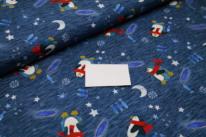Baumwolljersey Hilco Pingu Fisher Pinguine auf blau meliert